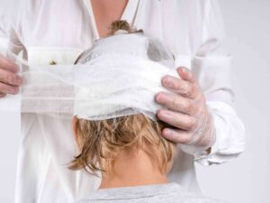 Doctor bandaging a patient's head