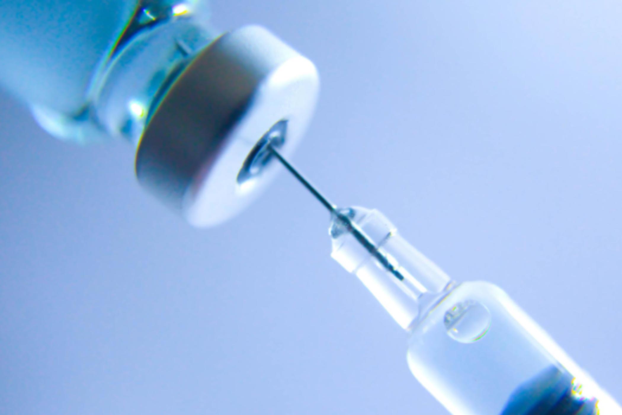 Activase-Therapy Syringe entering bottle blue background