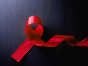 AIDS red ribbon on a dark background