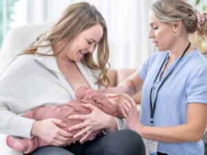 mom nursing baby with nurse's help