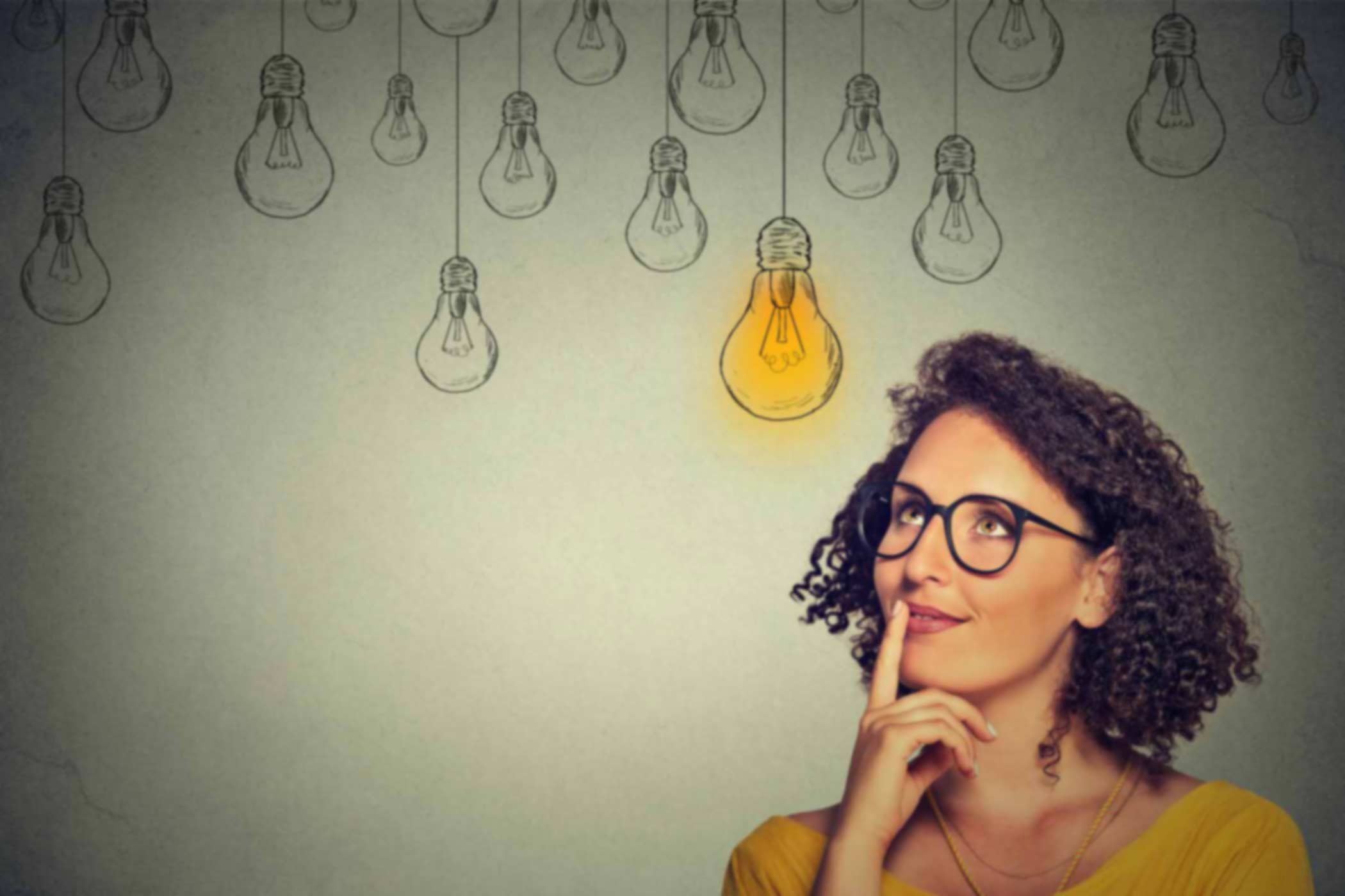 Critical-Thinking-Knowledge-Reflection-Action Woman thinking and looking at light bulbs drawings on wall