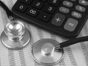 stethoscope with calculator on top of numbers sheet