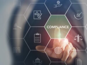 Compliance and regulation concept. Man's finger touching a compliance graphic on screen