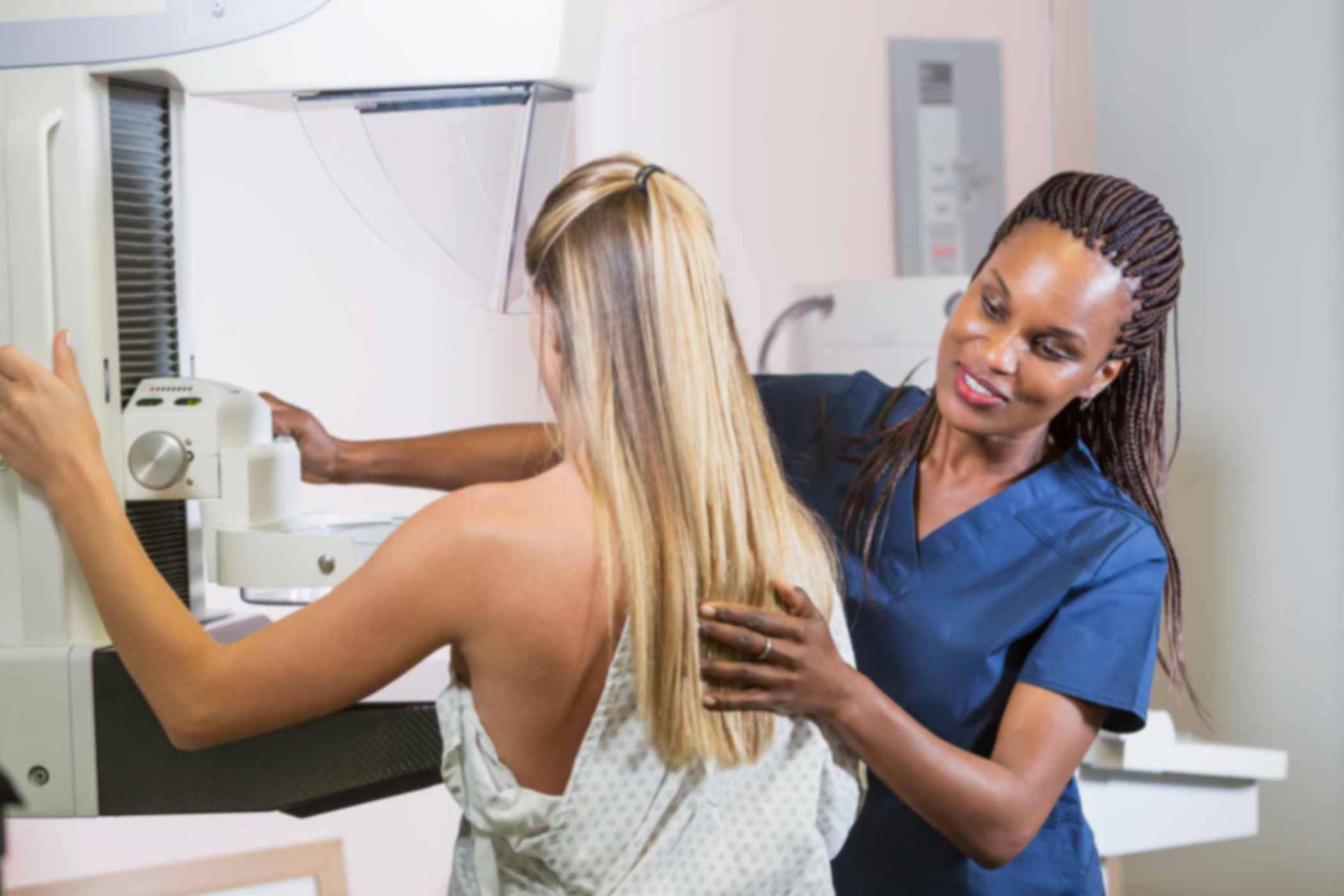 A-Nurses-Guide-to-Breast-Cancer nurse helping patient doing a mammogram