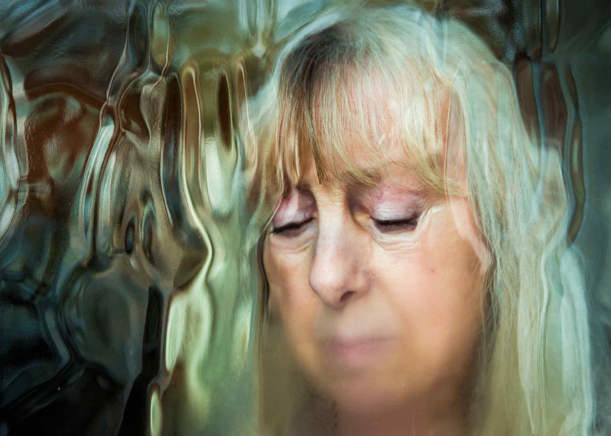 Elder-Abuse elder woman looking through a raining window